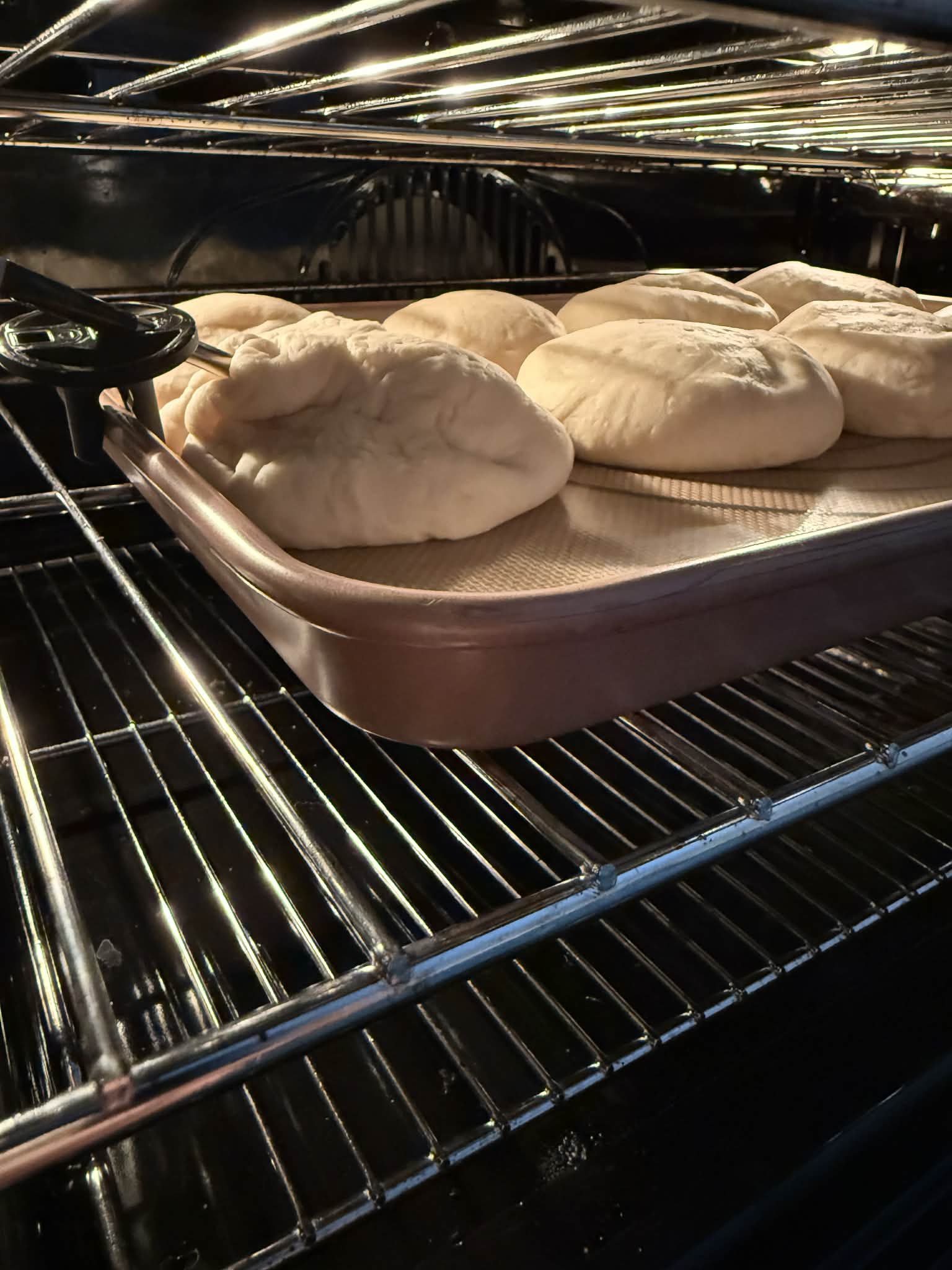 A Thermomix TM7 cooking pulled meat and a pasta bake side-by-side in the Varoma
